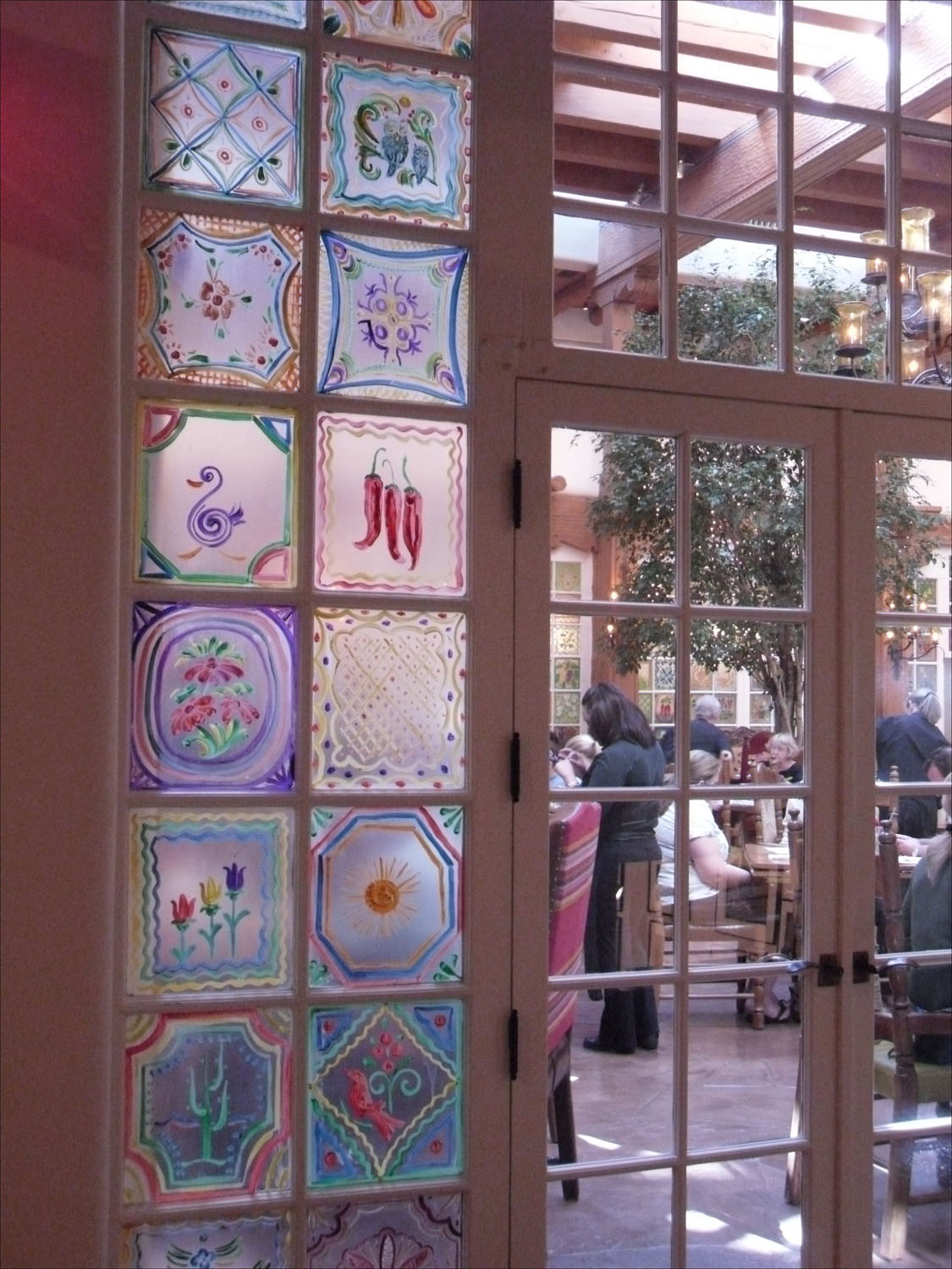 Santa Fe, NM-La Fonda Hotel details-painted window panels around atrium restaurant