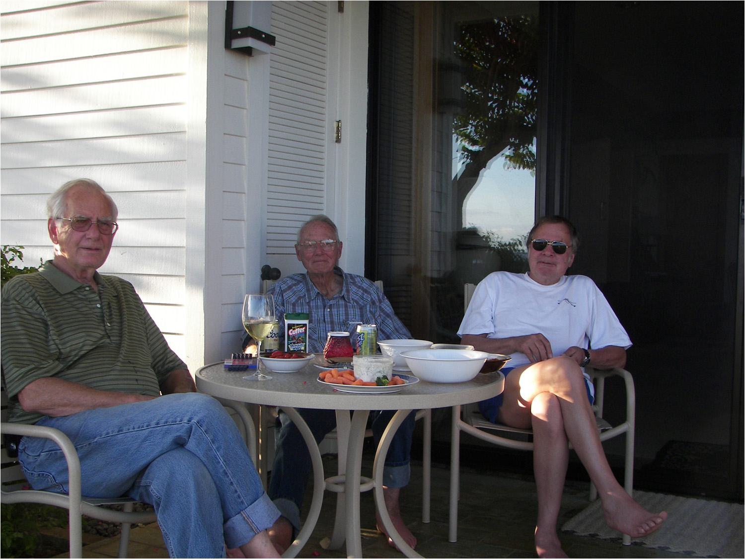 L-R, Pat, Steve, and Jay Burrall sitting on lanai at unit #6.