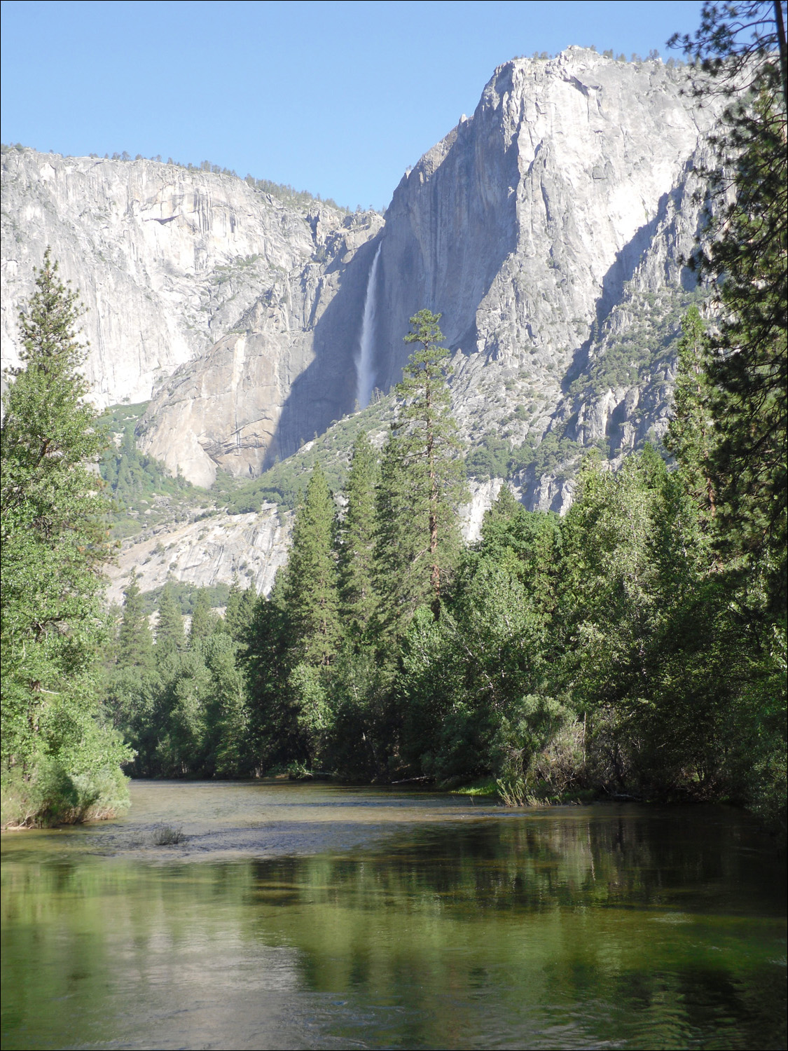 Merced River alongside Housekeeping with Yosemite Falls in te background