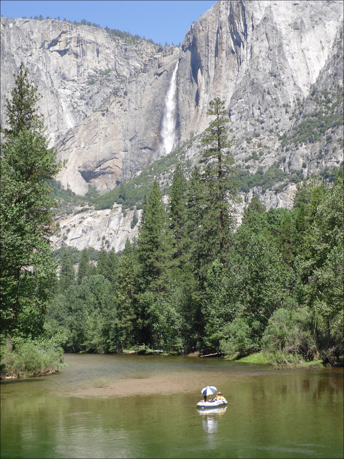 Merced River alongside Housekeeping with Yosemite Falls in te background~ and a rafter